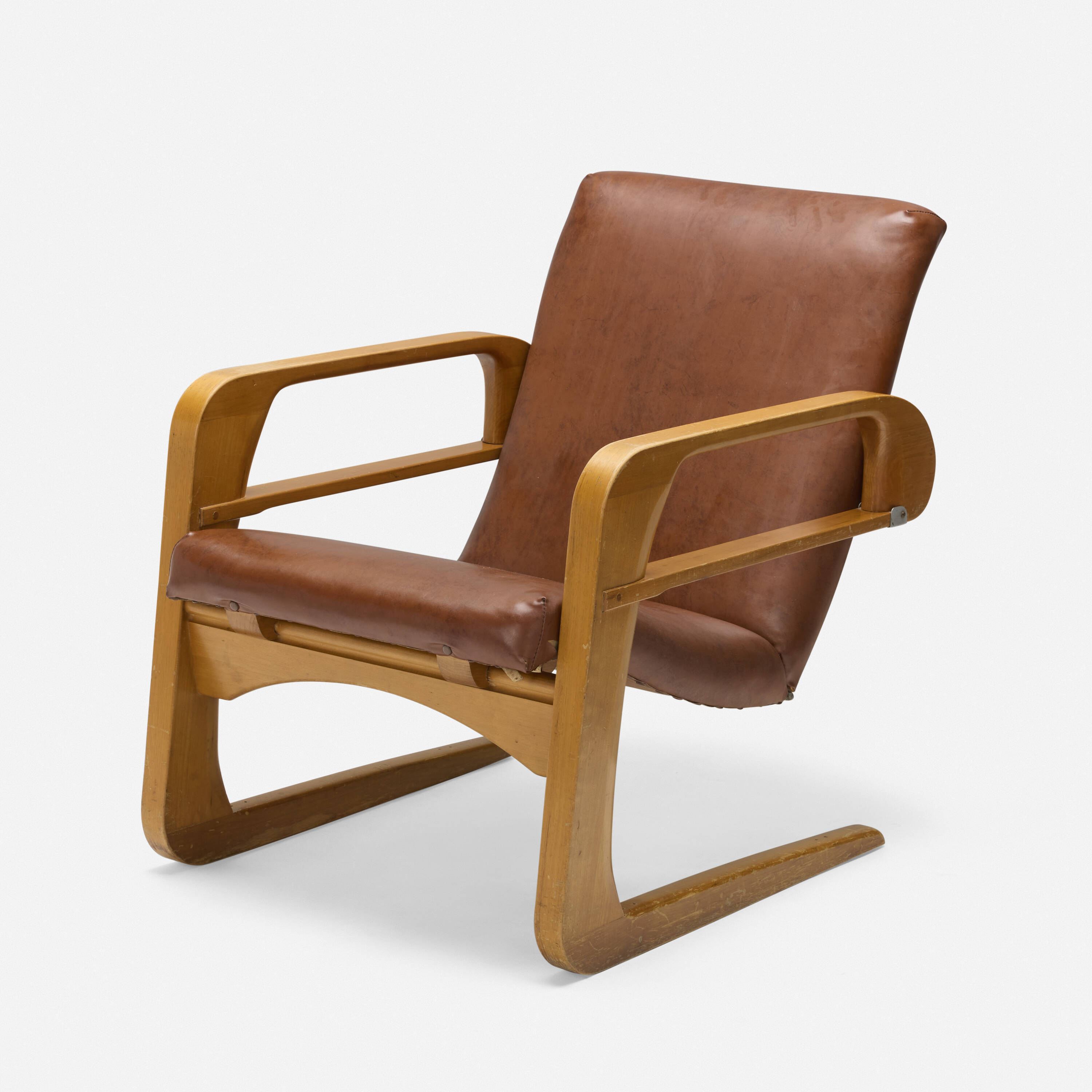 Kem Weber Airline Chair in saddle leather, three-quarter view